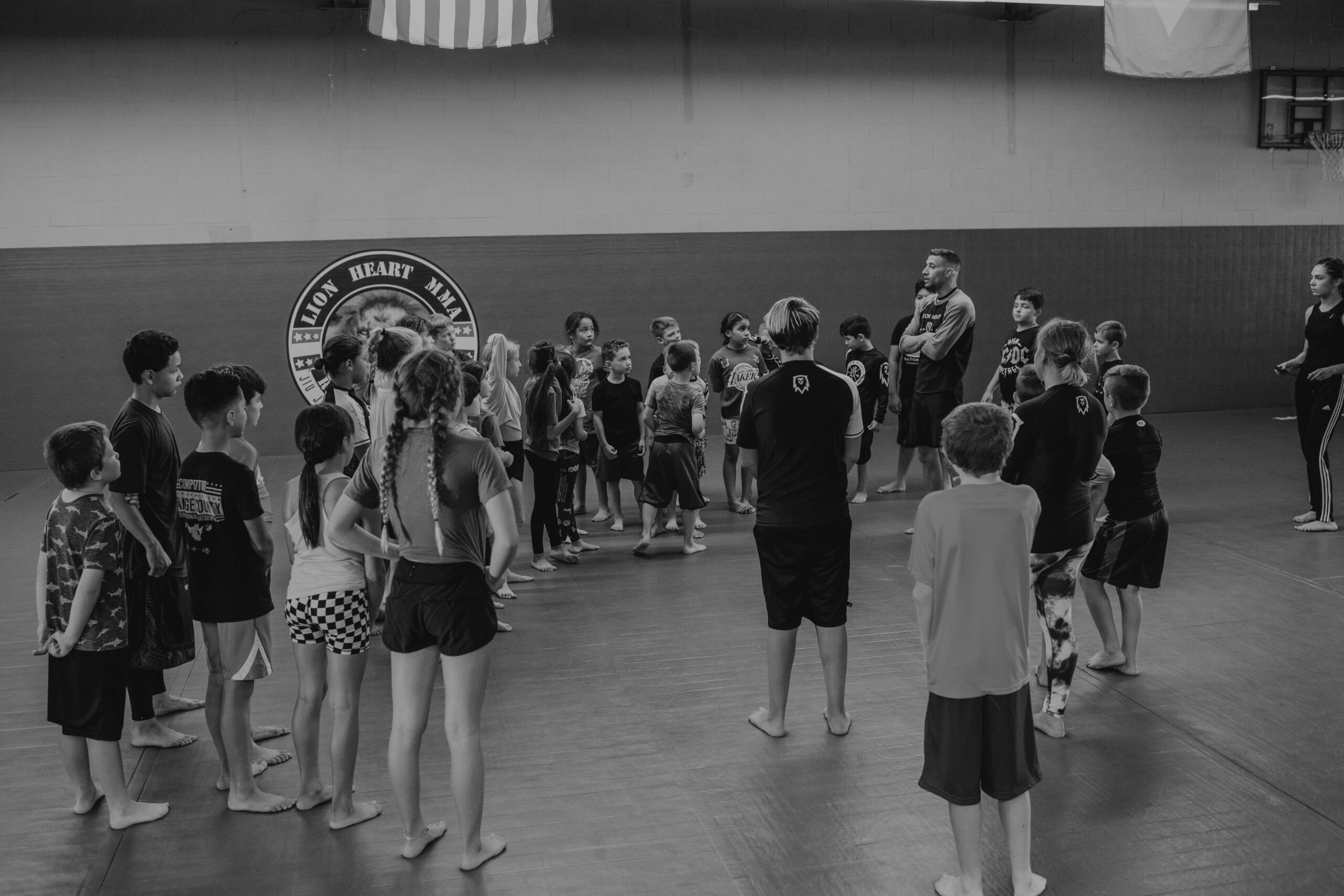 Black and white photo of MMA kids class